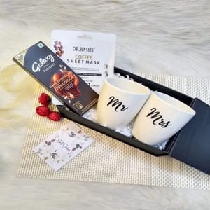 "Lets Make Memories Gift Box"-One  Pair of ivory white unbreakable coffee mugs ,galaxy dark chocolate bar ,coffee sheet mask from Dr. reshel ,a best wishes card For Festive gift