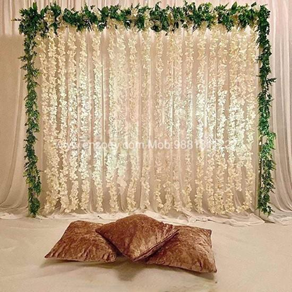 White floral hanging backdrop + greenery